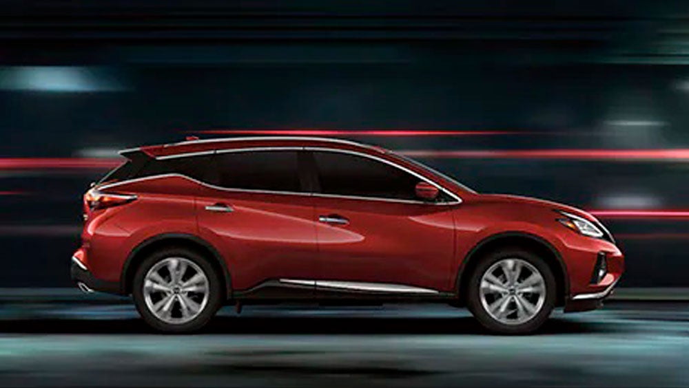 2023 Nissan Murano shown in profile driving down a street at night illustrating performance. | Andy Mohr Nissan in Indianapolis IN